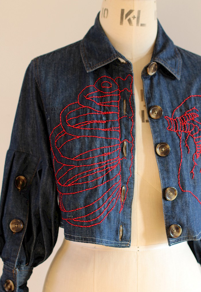 Denim jacket with embroidered anatomical elements