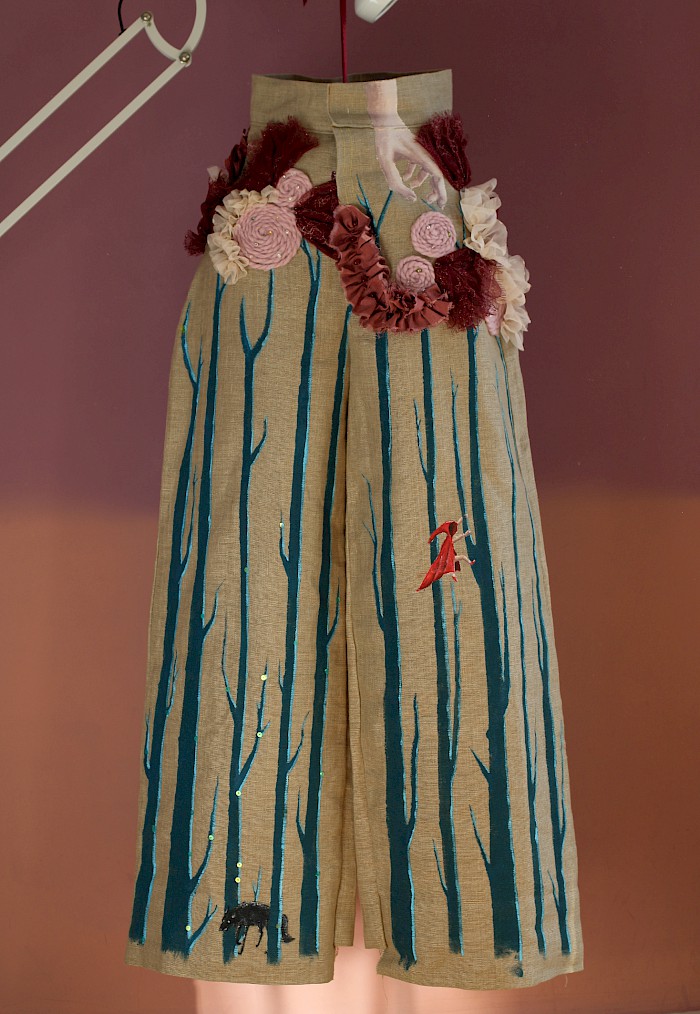 Full length image of trousers with applique and painted elements